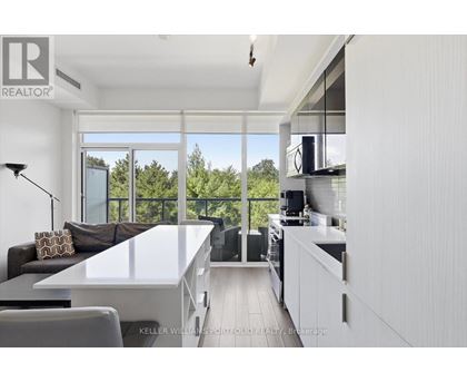 A modern kitchen with a dining table and chairs.