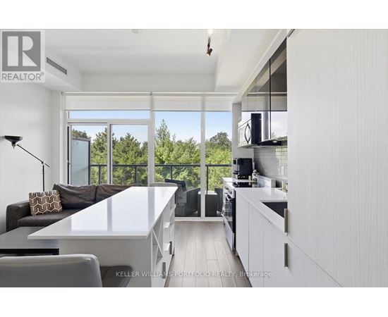A modern kitchen with a dining table and chairs.