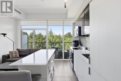 A modern kitchen with a dining table and chairs.