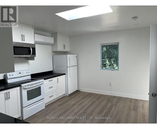 A kitchen with white appliances and cabinets.