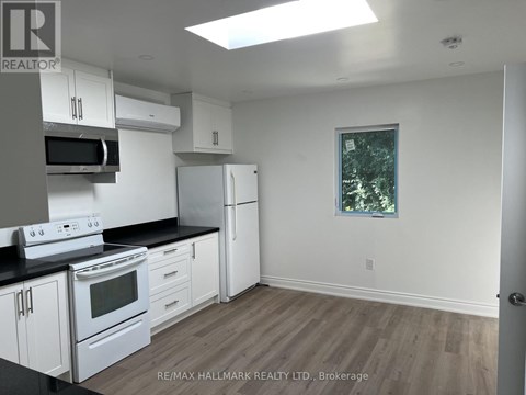 A kitchen with white appliances and cabinets.