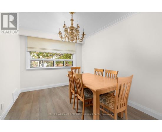 A dining room with a wooden table and chairs.