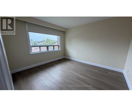 A room with a window and a view of a balcony.