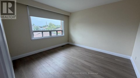 A room with a window and a view of a balcony.