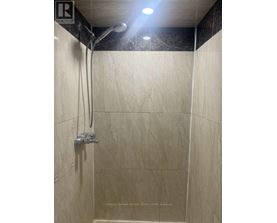 A shower area with a wall-mounted shower head.