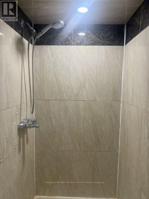 A shower area with a wall-mounted shower head.
