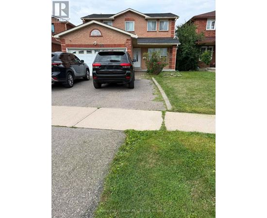 A black car is parked in front of a house.