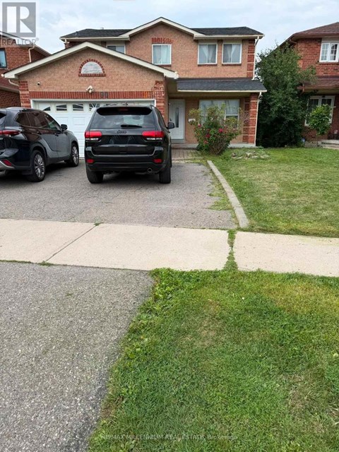 A black car is parked in front of a house.