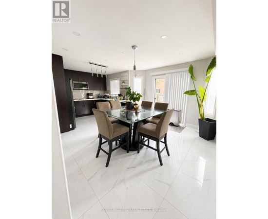 A modern dining room with a glass table and chairs.