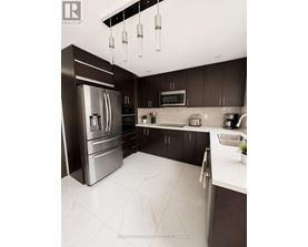 A modern kitchen with a stainless steel refrigerator and dark brown cabinets.