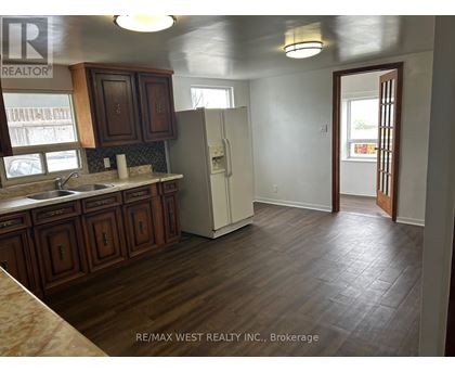 A kitchen with wooden cabinets and a white refrigerator.