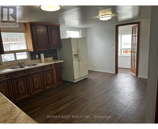 A kitchen with wooden cabinets and a white refrigerator.
