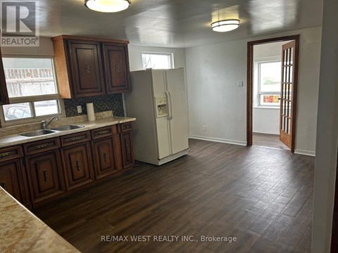 A kitchen with wooden cabinets and a white refrigerator.