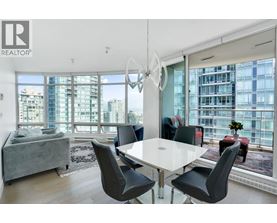A modern dining room with a large table and chairs.