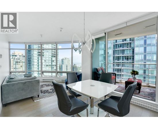 A modern dining room with a large table and chairs.