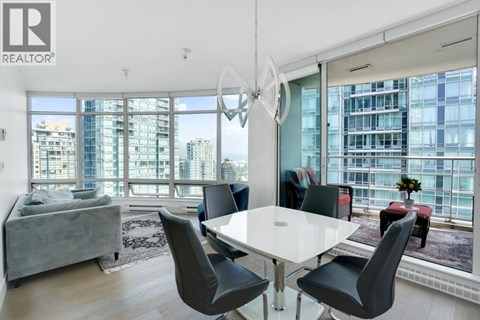 A modern dining room with a large table and chairs.