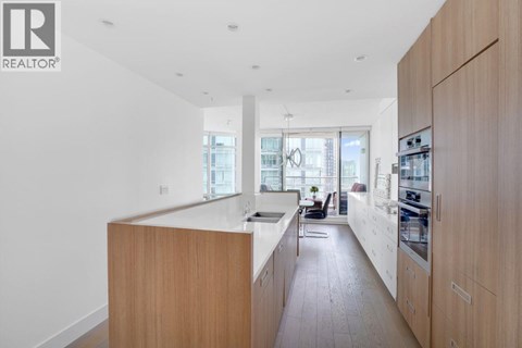 A modern kitchen with wooden cabinets and a large island.