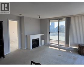 A living room with a fireplace and sliding glass doors.