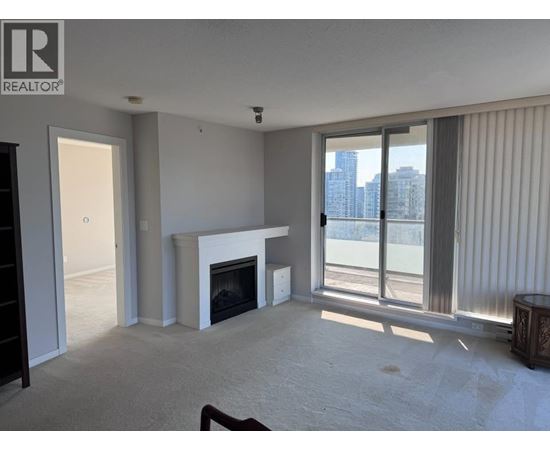 A living room with a fireplace and sliding glass doors.