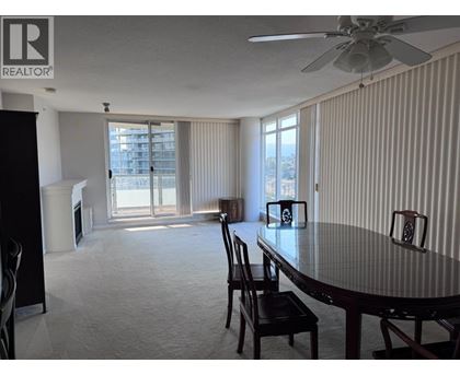 A dining room with a table and chairs.