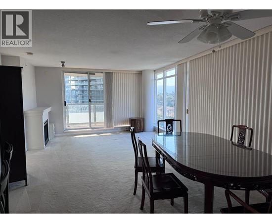 A dining room with a table and chairs.