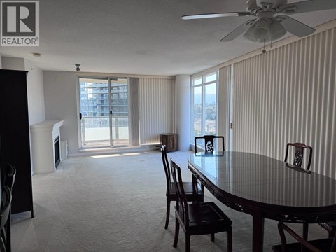 A dining room with a table and chairs.