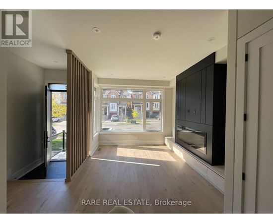 A spacious room with a view of the street through the window.