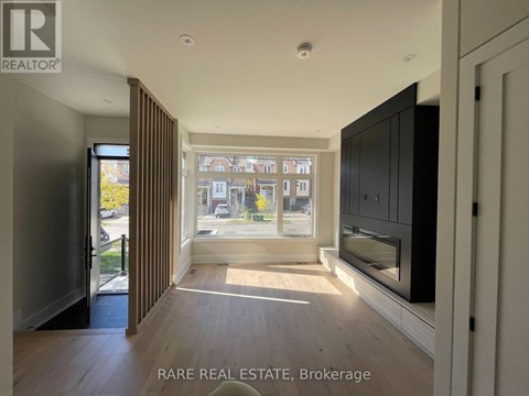 A spacious room with a view of the street through the window.