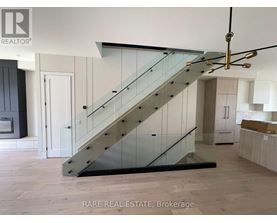 A staircase with a glass railing and wooden steps.