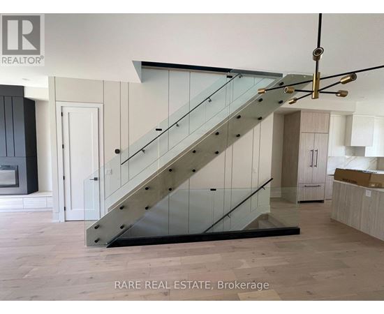 A staircase with a glass railing and wooden steps.
