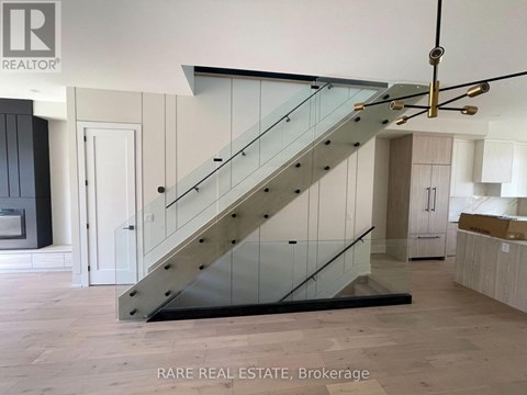 A staircase with a glass railing and wooden steps.