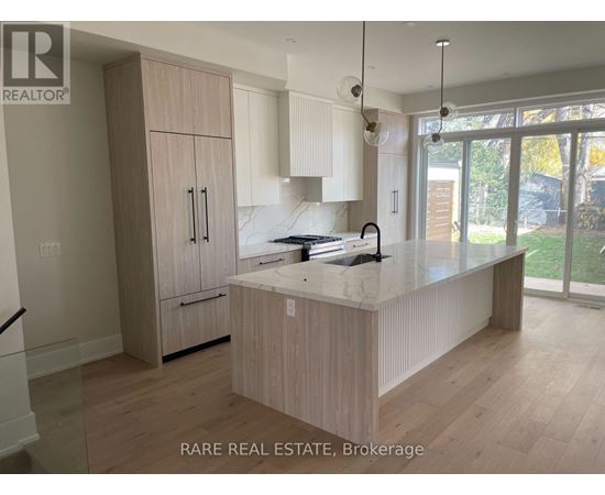 A kitchen with wooden cabinets and a marble countertop.