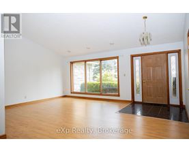 A room with wooden floors and a chandelier.