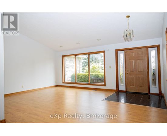 A room with wooden floors and a chandelier.
