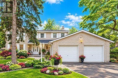 A house with a white garage door and a driveway.