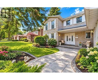 A house with a front yard and a driveway.