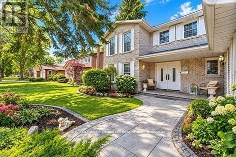 A house with a front yard and a driveway.