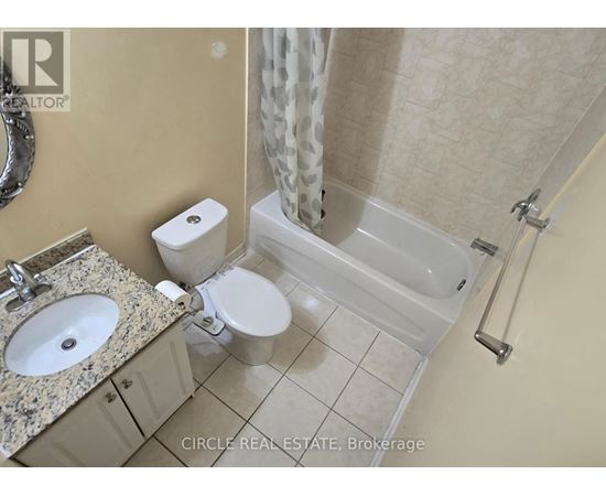 A bathroom with a toilet, sink, and bathtub.