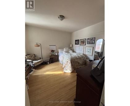 A room with a bed, a couch, and a desk.