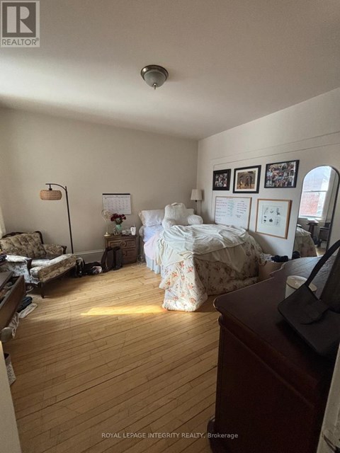 A room with a bed, a couch, and a desk.