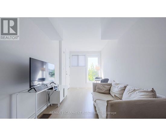 A living room with a television and a couch.