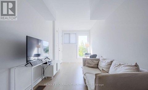 A living room with a television and a couch.