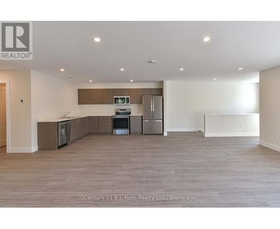 A spacious kitchen with wooden cabinets and stainless steel appliances.