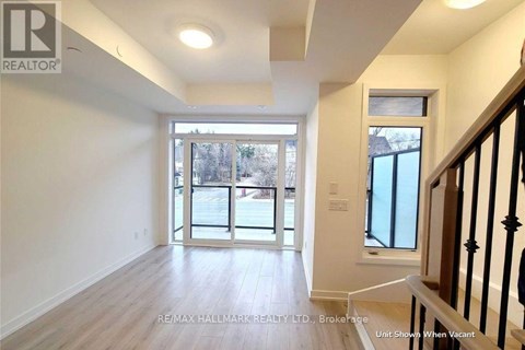 A spacious room with a view of the street through the glass doors.