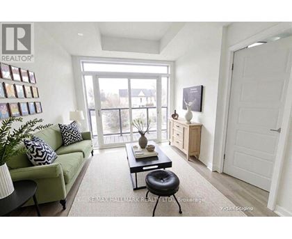 A living room with a green couch, a black coffee table, and a white door.
