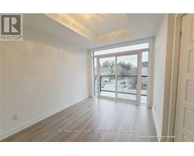 A room with a sliding glass door leading to a balcony.