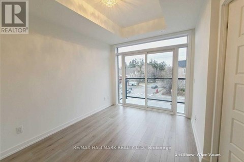 A room with a sliding glass door leading to a balcony.