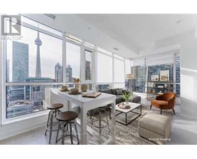 A modern dining room with a view of the city skyline.
