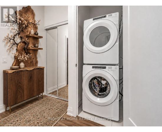 A washer and dryer are stacked on top of each other in a laundry room.