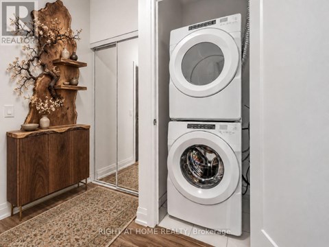 A washer and dryer are stacked on top of each other in a laundry room.